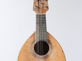 a guitar hanging from a string on the wall