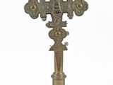 a cross that is on a pedestal on a white background