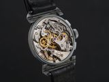an image of a close up of a watch on a black surface
