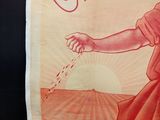 a poster of a woman watering water on a field