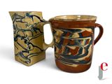 two mugs sitting next to each other on a white surface