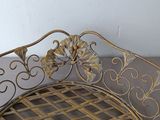 a metal bench that has a decorative design on it