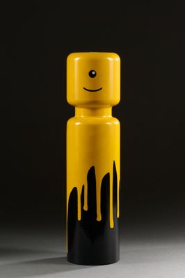 a yellow and black bottle with a smiley face on it