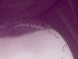 a close up view of a purple vase with writing on it