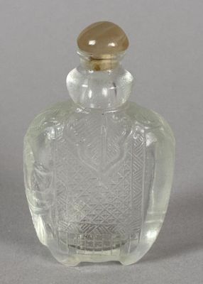 a clear glass bottle with a gold lid