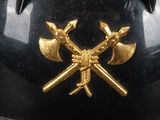 a black helmet with two crossed axes on it