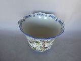 a blue and white flowered vase sitting on a table