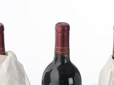 three bottles of wine sitting next to each other on a table