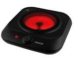 a black and red stove top with a red light on it
