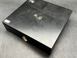 an image of a black box with a gold monogram on it