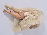 a doll that is laying down on a cloth