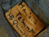 a close up of a plate with a sign on it