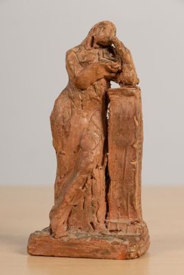 a statue of a man and a woman sitting on a table