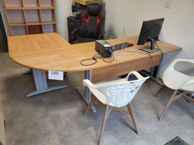 a desk with two chairs and a computer on it