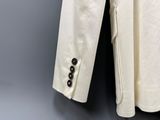 an image of a white jacket hanging on a hanger