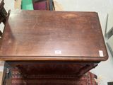 a small wooden table with a drawer on top of it