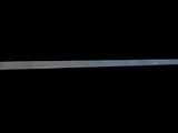 an image of a wooden spoon with a metal handle on a black background