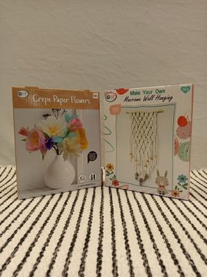 two books on the table with a vase of flowers in it