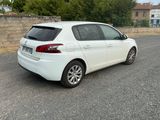 a white car that is parked on the side of the road