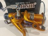 a close up of a fishing reel with a box in the background