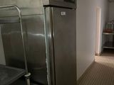 an image of a kitchen with stainless steel appliances and tile flooring