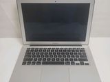 an open laptop computer sitting on top of a white table