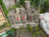 a pile of sticks sitting on the ground next to a pile of flowers