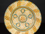 an orange and blue plate with a design on it