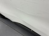 the car is white and has a black stripe on the side of it