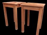 pair of wooden side tables on a black background with a black background