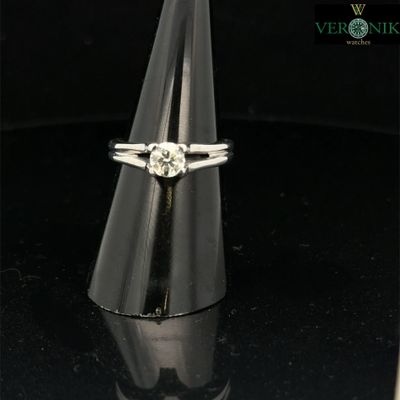 a close up of a diamond ring on a black surface