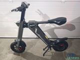 a scooter that is parked in front of a garage door
