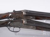 two guns are on display in a glass case
