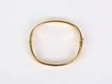a close up of a gold ring on a white surface