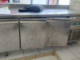 a stainless steel counter top in a kitchen with a window
