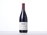 a bottle of red wine sitting on top of a table