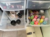 two plastic drawers that are filled with cosmetics and nail polish