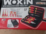 a box of tools sitting on the floor next to a pair of scissors