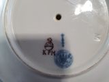 a white plate with a blue and red design on it
