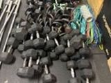 a lot of dumbbells on the floor in the gym