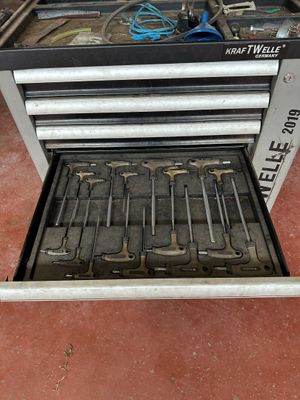 a tool box with tools inside of it on the floor