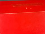 two red boxes stacked on top of each other on a table