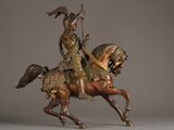 bronze statue of a man on a horse with a spear in his hand