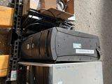 un tas d'appareils électroniques posé par terre à côté d'un banc