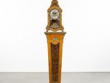 a clock that is standing in the middle of a room
