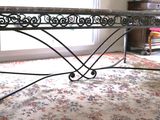 a table that is sitting on a rug in a room