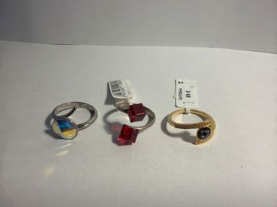 four different colored rings sitting on top of a white table