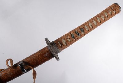 a close up of a samurai sword on a white background