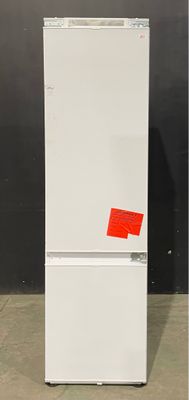 an image of a white refrigerator with a red sticker on it