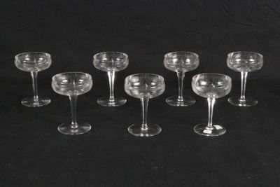 six wine glasses are lined up in a row on a black background
